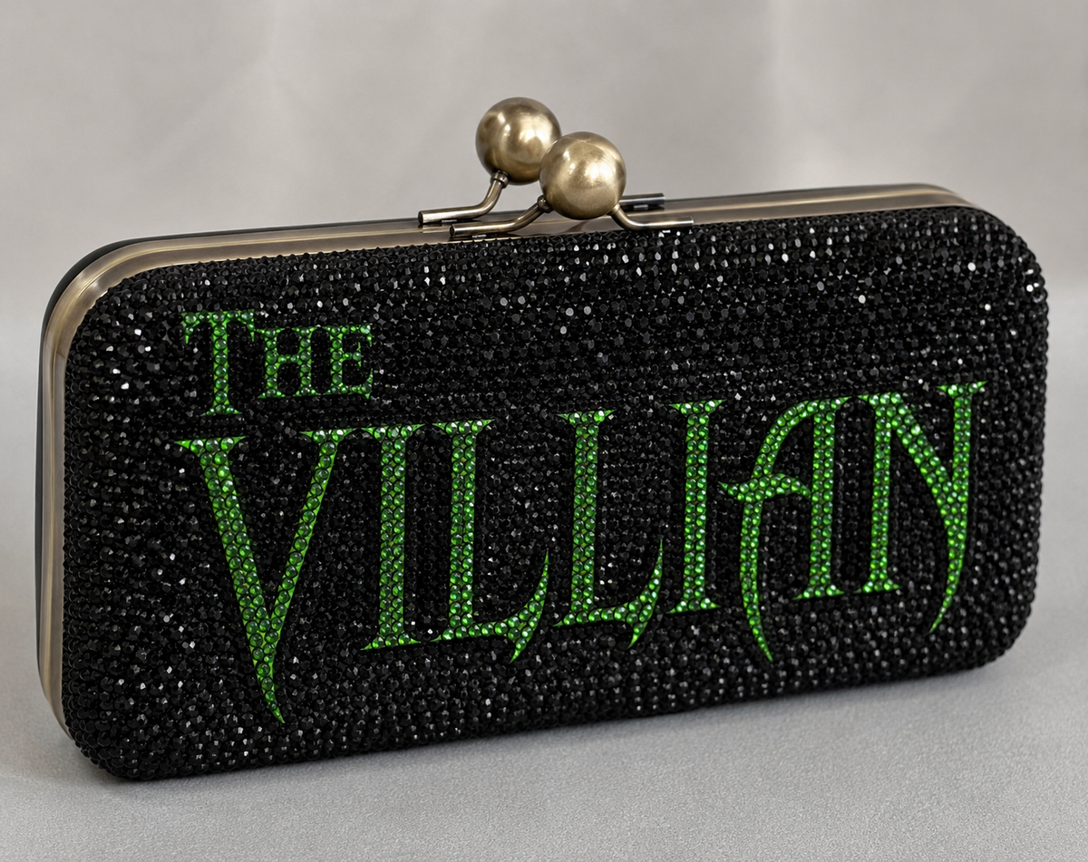 THE VILLAIN black rhinestone clutch with green crystal lettering studio product photo